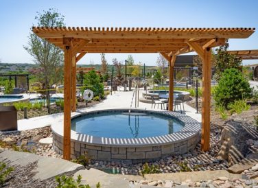 Outdoor pool under pergola outside at WorldSprings The Colony, TX